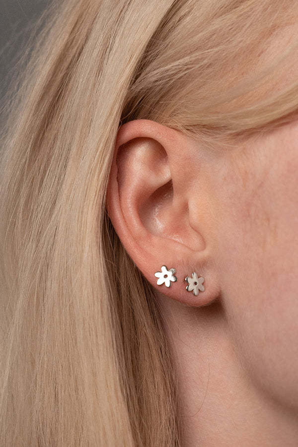 Close Up Detail of Two Flower Studs in Sterling Silver