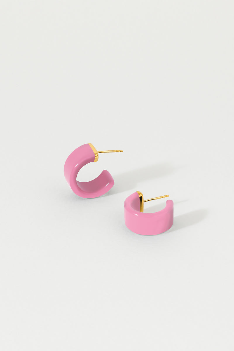 A pair of rose pink huggie earrings with 18K gold plated sterling silver studs on a white background.