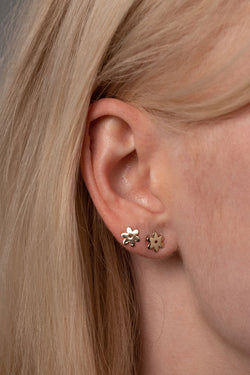 Close Up Detail of Two Flower Studs in Golden Brass