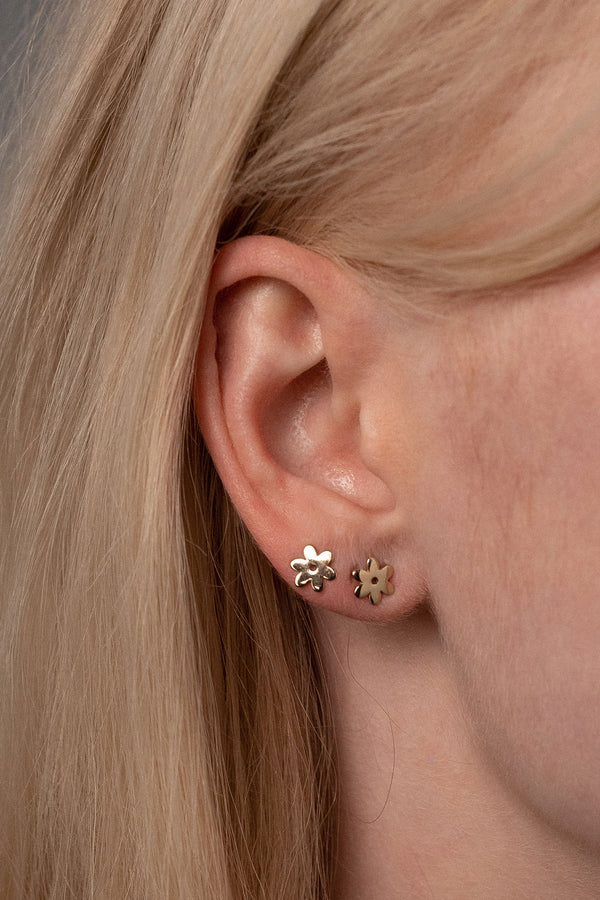 Close Up Detail of Two Flower Studs in Golden Brass