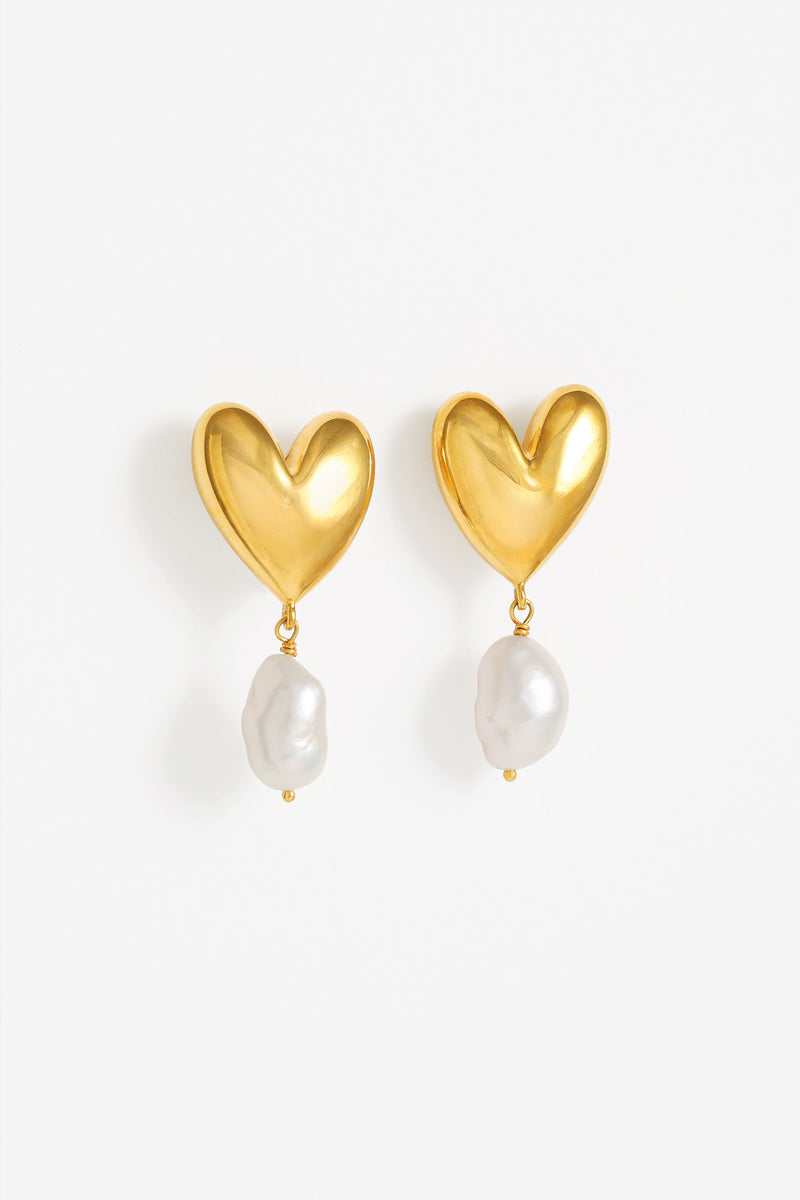 Large voluminous heart studs in gold with articulated hanging feature nugget pearl. Bold and beautiful. 